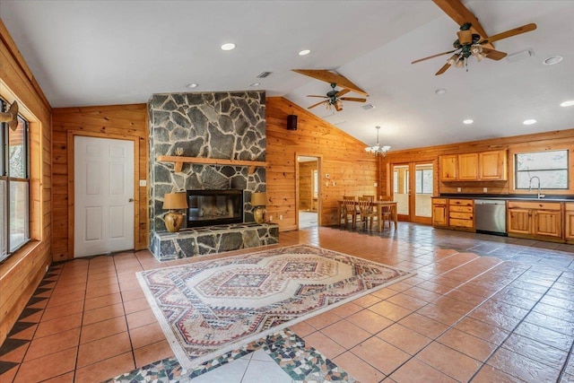 220 Deer Pass, Havana, FL 32333 - living room featuring wooden walls, a fireplace, lofted ceiling, and ceiling fan with notable chandelier