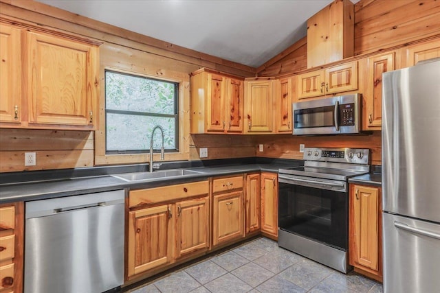220 Deer Pass, Havana, FL 32333 - kitchen with dark countertops, a sink, appliances with stainless steel finishes, light tile patterned floors, and vaulted ceiling