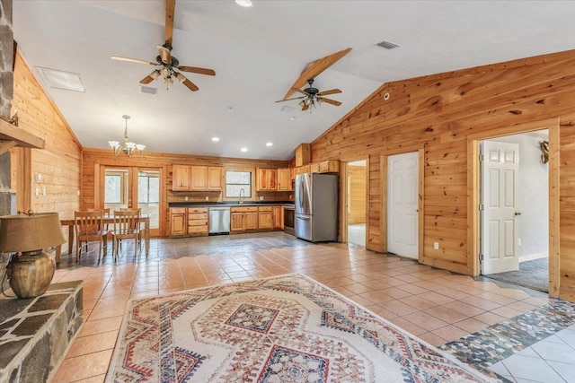 220 Deer Pass, Havana, FL 32333 - kitchen with wooden walls, dark countertops, ceiling fan with notable chandelier, stainless steel appliances, and light tile patterned floors