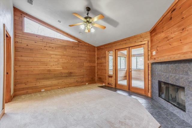 220 Deer Pass, Havana, FL 32333 - unfurnished living room featuring french doors, vaulted ceiling, and wood walls
