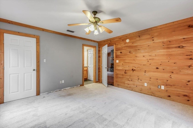 220 Deer Pass, Havana, FL 32333 - empty room featuring visible vents, carpet flooring, a ceiling fan, and wooden walls