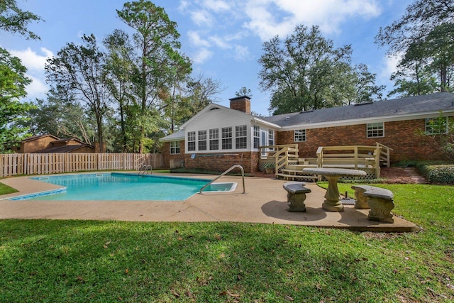 view of swimming pool with a lawn, a patio area, and a wooden deck