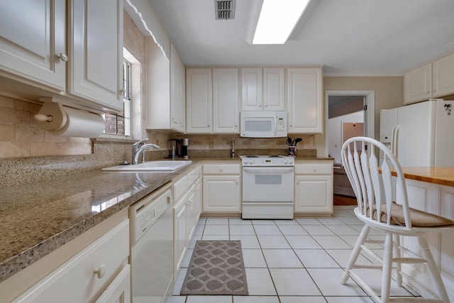 kitchen featuring white cabinetry, white appliances, sink, and tasteful backsplash