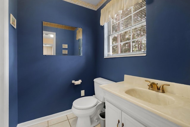 bathroom with tile patterned flooring, vanity, and toilet