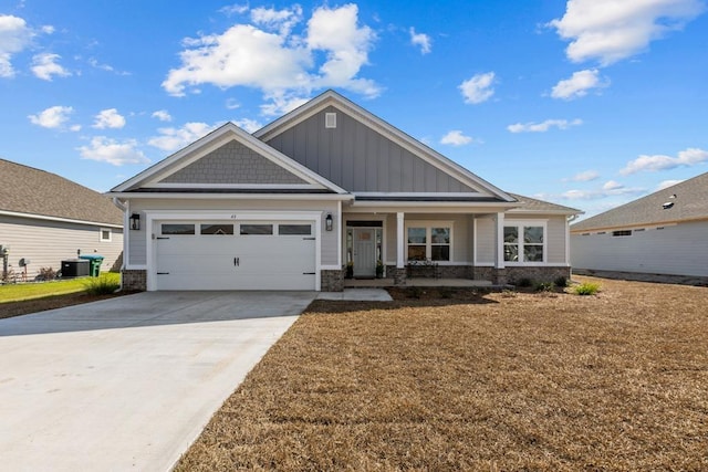 craftsman-style home featuring board and batten siding, central air condition unit, driveway, stone siding, and an attached garage