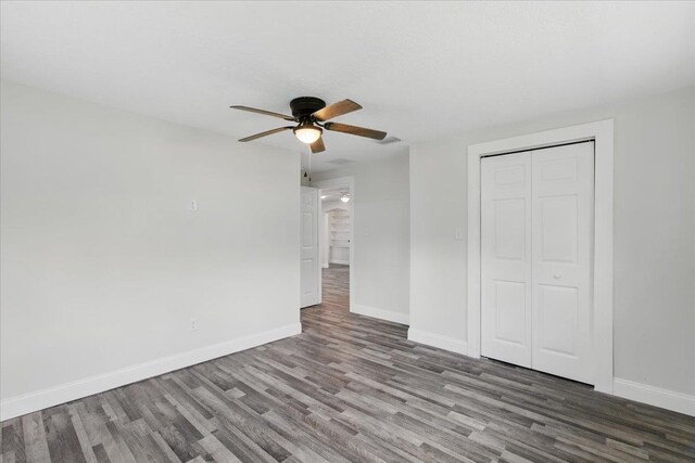 1822 N US-221, Perry, FL 32347 - unfurnished bedroom with baseboards, a ceiling fan, wood finished floors, and a closet