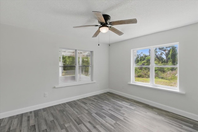 1822 N US-221, Perry, FL 32347 - unfurnished room with a textured ceiling, baseboards, a ceiling fan, and wood finished floors
