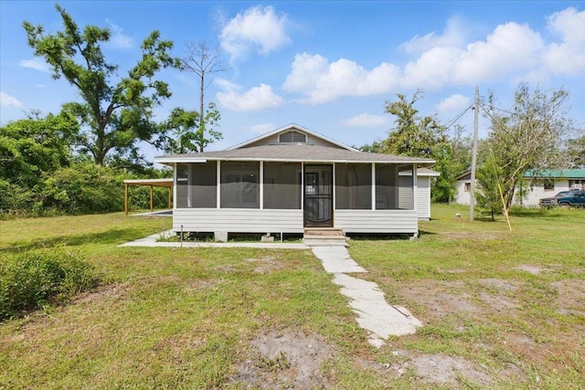 1822 N US-221, Perry, FL 32347 - view of front of property featuring a sunroom, a shingled roof, and a front lawn