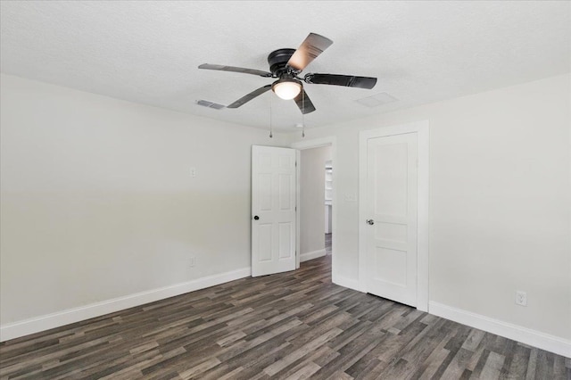 1822 N US-221, Perry, FL 32347 - empty room with ceiling fan, a textured ceiling, baseboards, visible vents, and dark wood-style floors