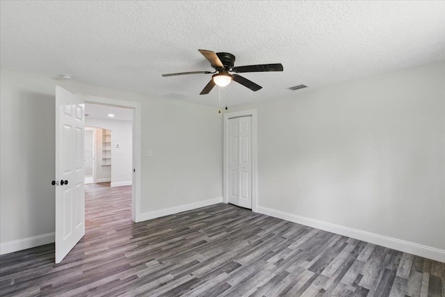 1822 N US-221, Perry, FL 32347 - empty room featuring a ceiling fan, a textured ceiling, visible vents, and dark wood-type flooring