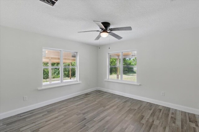 1822 N US-221, Perry, FL 32347 - spare room with a textured ceiling, baseboards, a ceiling fan, and wood finished floors