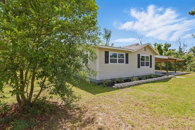 1822 N US-221, Perry, FL 32347 - view of property exterior featuring a yard and an attached carport