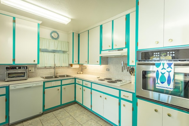 kitchen featuring white cabinetry, sink, backsplash, white appliances, and light tile patterned floors