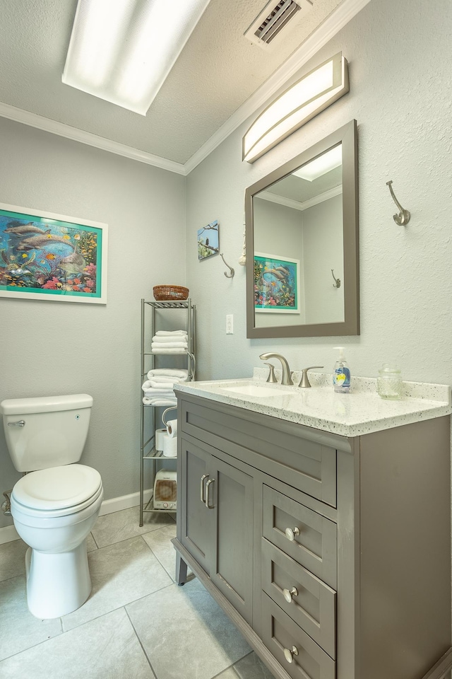 bathroom featuring tile patterned flooring, crown molding, a textured ceiling, toilet, and vanity