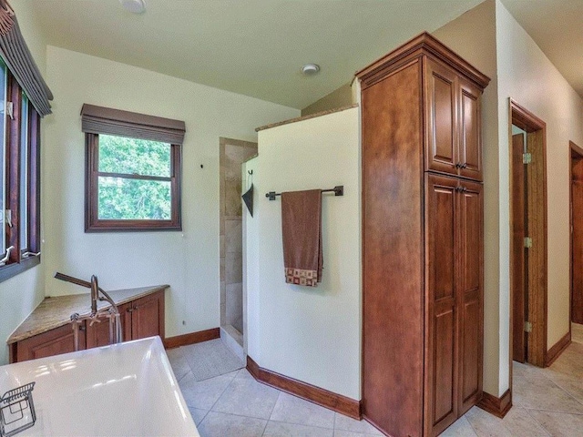 bathroom featuring tile patterned flooring and a shower