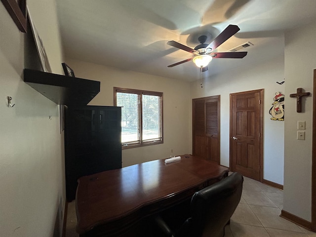 tiled office featuring ceiling fan