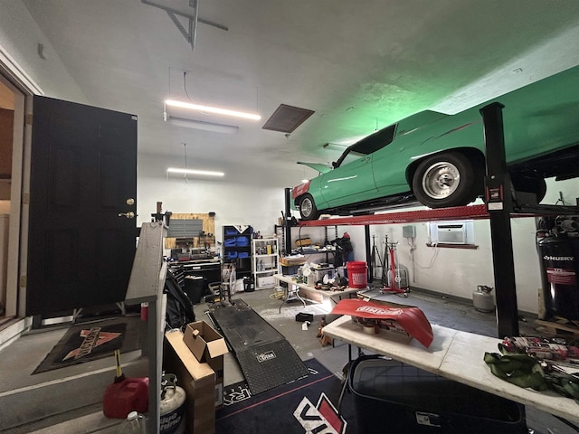 garage with a workshop area and an AC wall unit