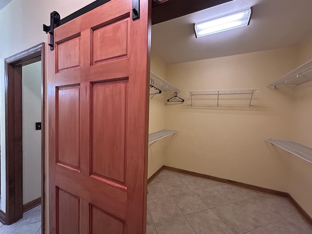 spacious closet with a barn door