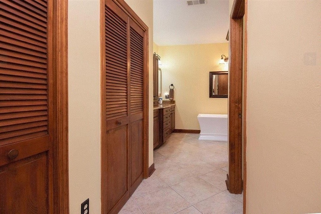 corridor featuring light tile patterned floors