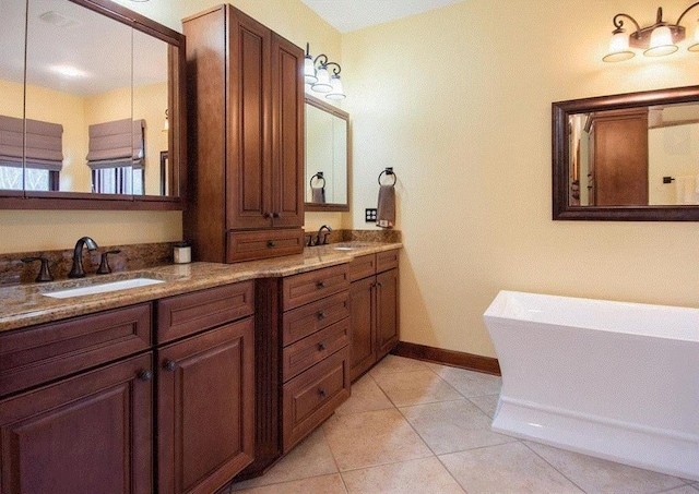 bathroom with vanity, a bath, and tile patterned flooring