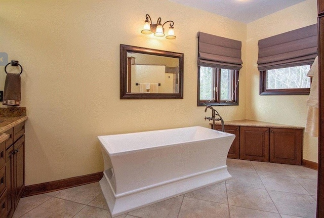 bathroom with tile patterned floors, vanity, and a bathtub