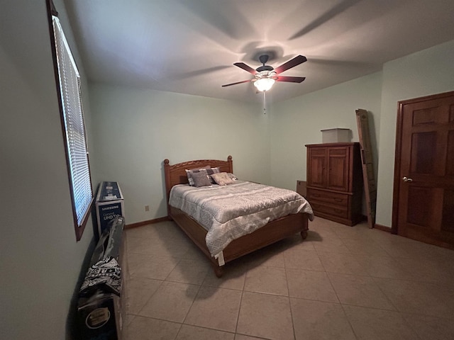 tiled bedroom featuring ceiling fan