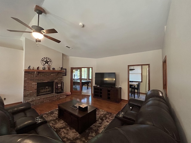 living room with vaulted ceiling, hardwood / wood-style floors, ceiling fan, and a fireplace