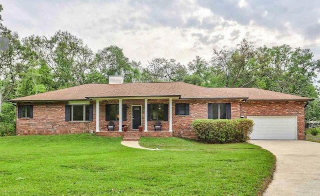 ranch-style house with a garage, covered porch, and a front lawn