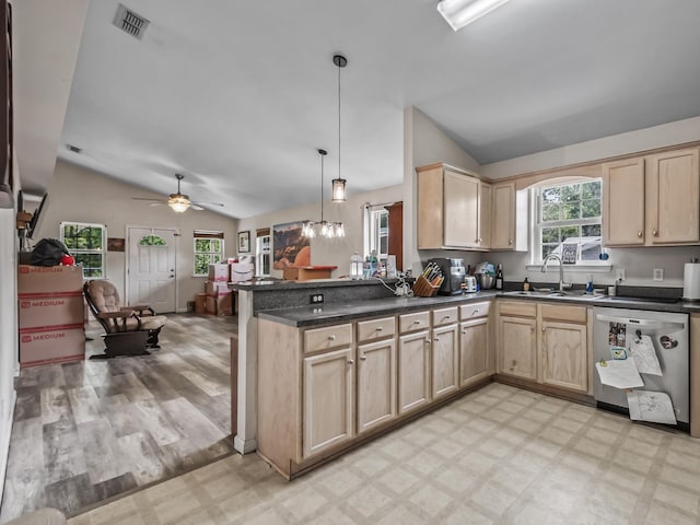 172 Mohave Rd, Crawfordville, FL 32327 - kitchen featuring stainless steel dishwasher, light brown cabinetry, vaulted ceiling, light floors, and dark countertops
