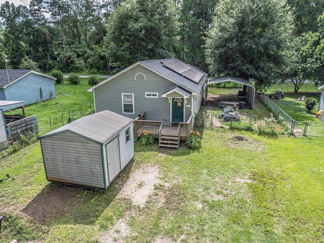 172 Mohave Rd, Crawfordville, FL 32327 - back of property featuring a wooden deck, a fenced backyard, and a storage unit