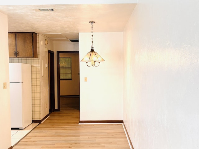 133 Boardwalk Ln, Tallahassee, FL 32301 - unfurnished dining area with light wood-type flooring and baseboards