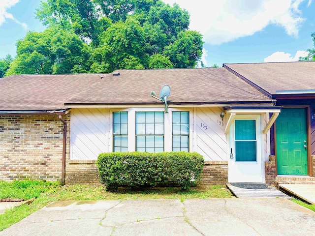 133 Boardwalk Ln, Tallahassee, FL 32301 - doorway to property with roof with shingles and brick siding