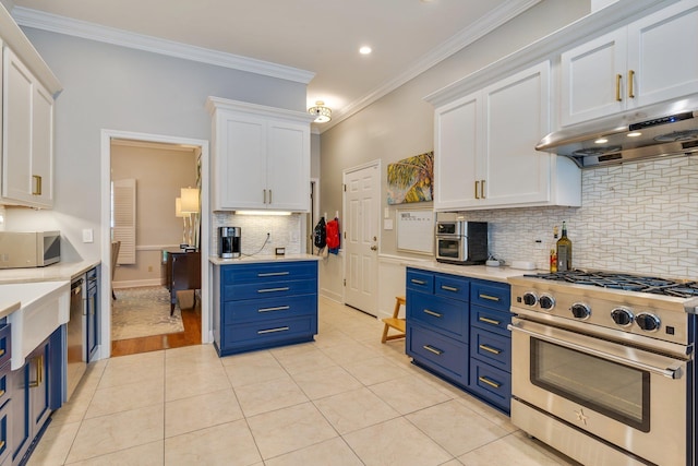3690 Dexter Dr, Tallahassee, FL 32312 - kitchen with stainless steel appliances, blue cabinets, under cabinet range hood, white cabinets, and light countertops