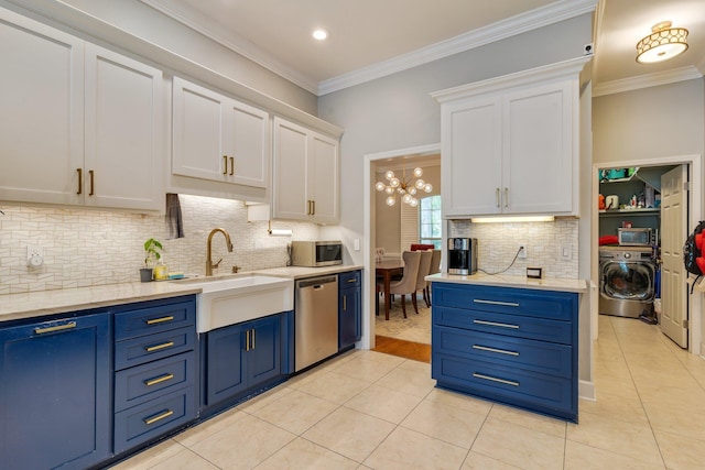 3690 Dexter Dr, Tallahassee, FL 32312 - kitchen featuring washer / clothes dryer, blue cabinetry, appliances with stainless steel finishes, white cabinets, and crown molding