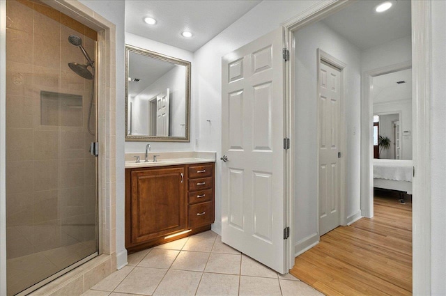 4664 Fledgling Dr, Tallahassee, FL 32311 - ensuite bathroom with a shower stall, vanity, recessed lighting, tile patterned flooring, and baseboards