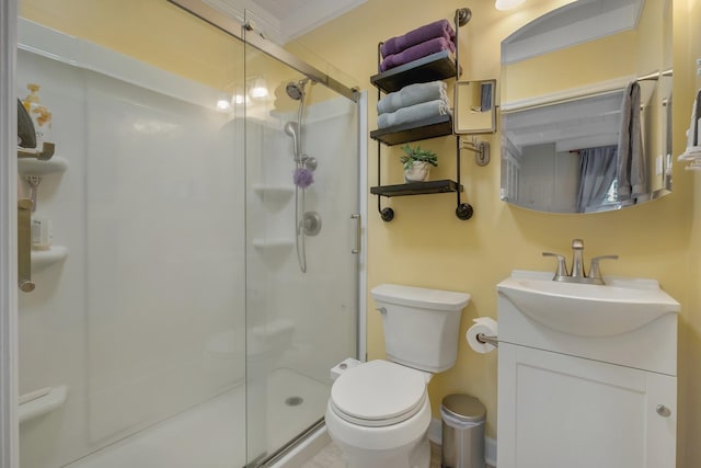 bathroom featuring a shower with door, vanity, and toilet