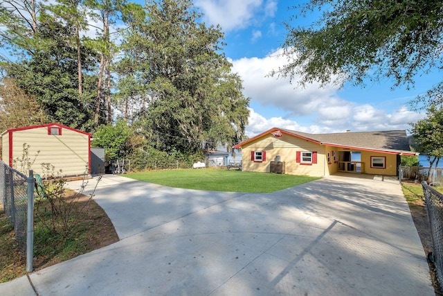 view of front of property with a front lawn and a storage unit