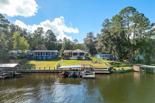 dock area featuring a lawn and a water view