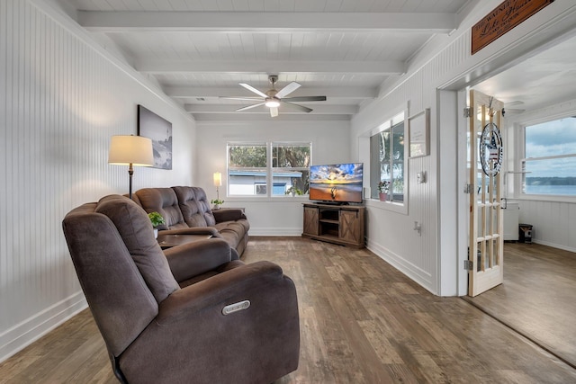 living room with beam ceiling, hardwood / wood-style flooring, and ceiling fan