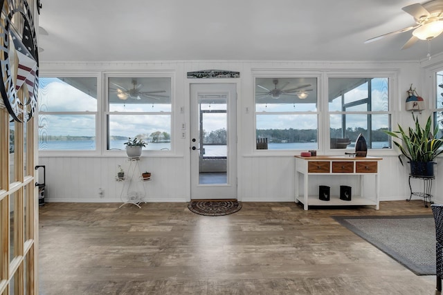 interior space featuring a water view and ceiling fan