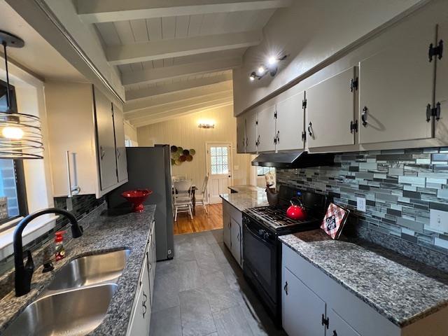 kitchen with lofted ceiling with beams, tasteful backsplash, sink, and black range with gas stovetop