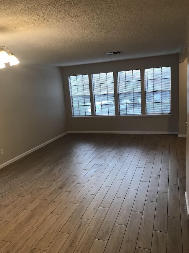 2247 Shady Timbers Cir Unit C, Tallahassee, FL 32304 - unfurnished room with a textured ceiling and wood finished floors