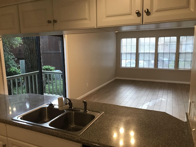 2247 Shady Timbers Cir Unit C, Tallahassee, FL 32304 - kitchen with white cabinetry and wood finished floors