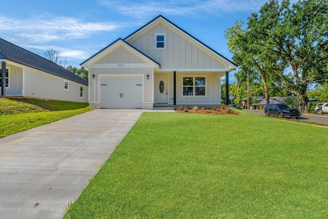 1421 Stuckey Ave, Tallahassee, FL 32310 - modern farmhouse with board and batten siding, driveway, a garage, and a front yard