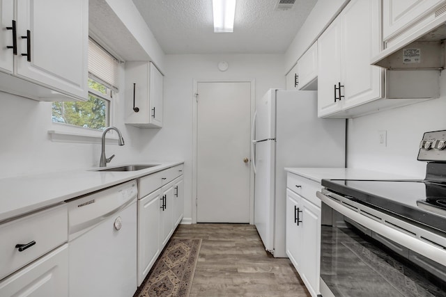 kitchen with sink, white cabinetry, a textured ceiling, electric range, and white dishwasher