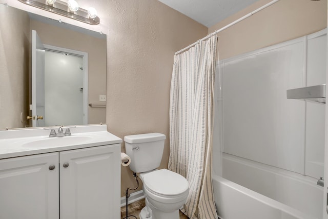 full bathroom with vanity, shower / tub combo, and toilet