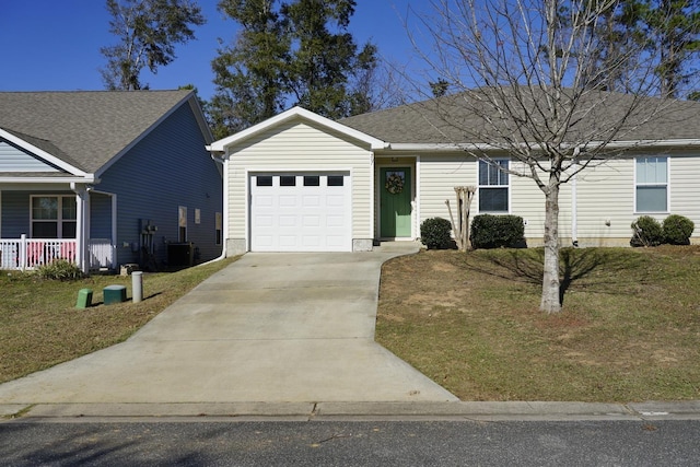 single story home with a garage and a front lawn