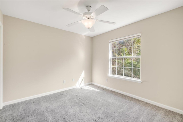 empty room featuring ceiling fan and carpet floors