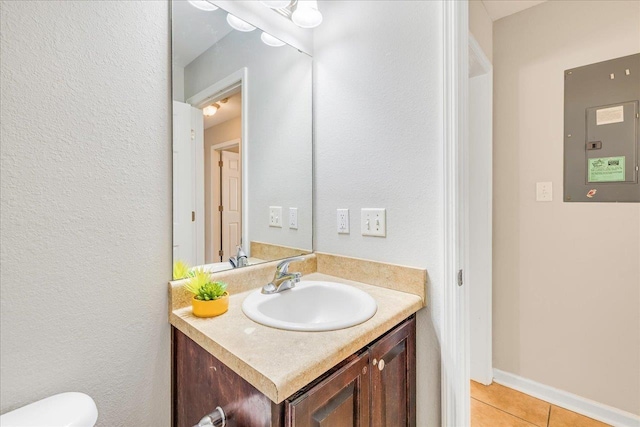 bathroom featuring tile patterned floors, vanity, and electric panel