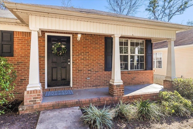 view of exterior entry with covered porch